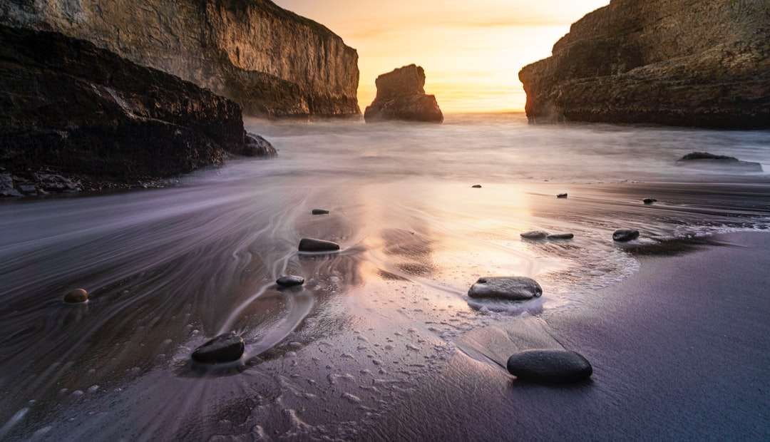 brown rock formation on sea shore during daytime jigsaw puzzle online