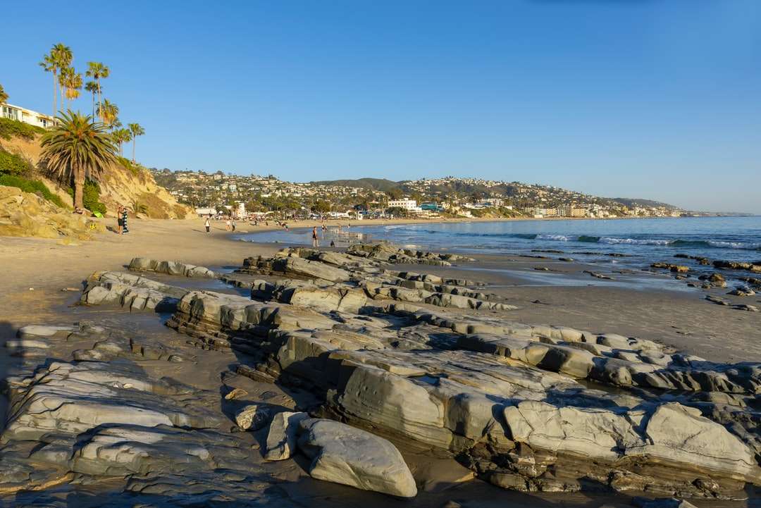 grå stenig strand nära vattendrag under dagtid Pussel online