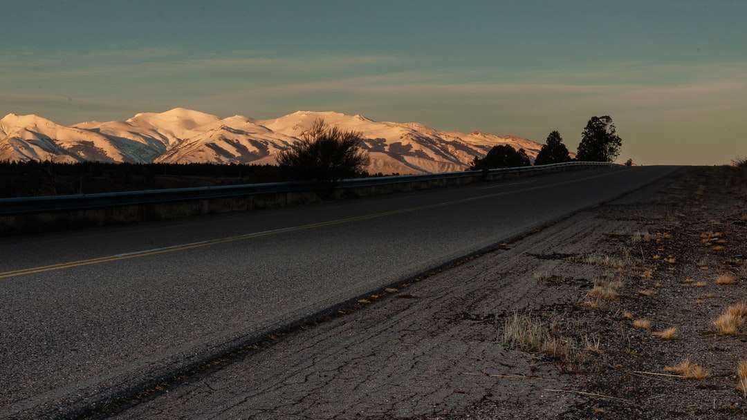 Carretera de asfalto negro cerca de las montañas marrones durante el día rompecabezas en línea