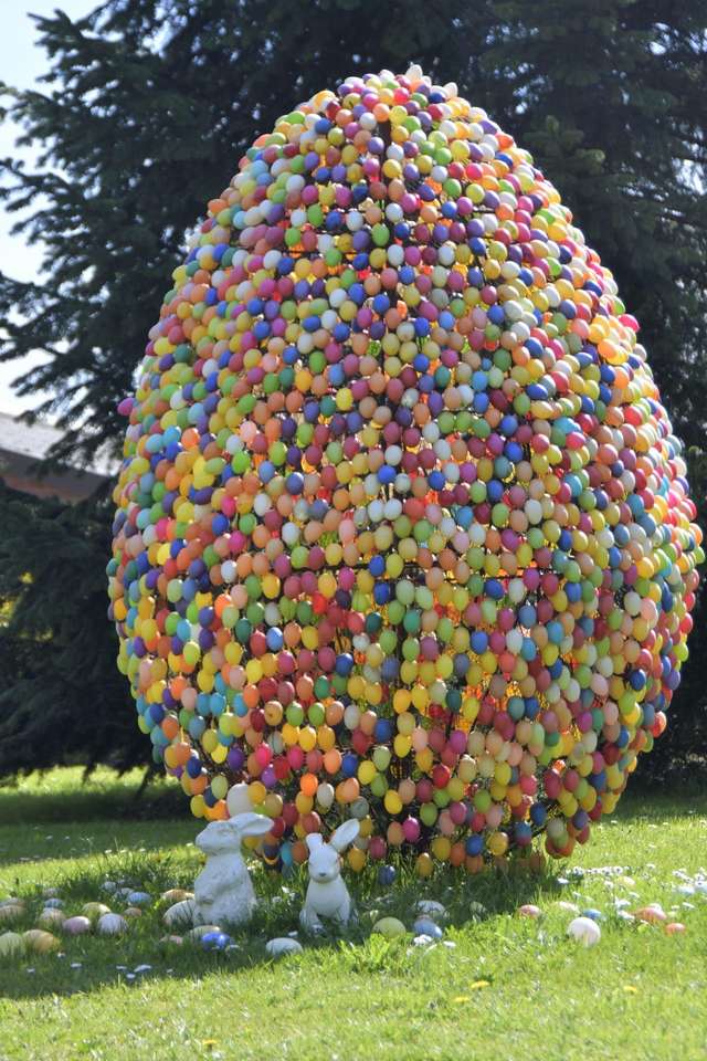 Easter giant easter egg with rabbits in the garden jigsaw puzzle online