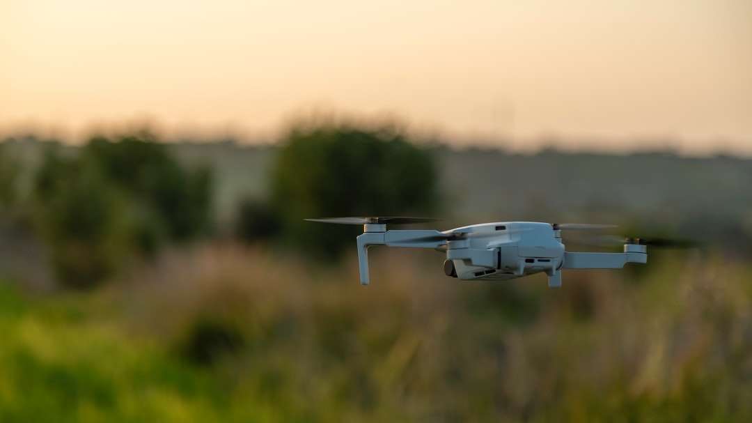бял дрон, летящ над полето със зелена трева през деня онлайн пъзел