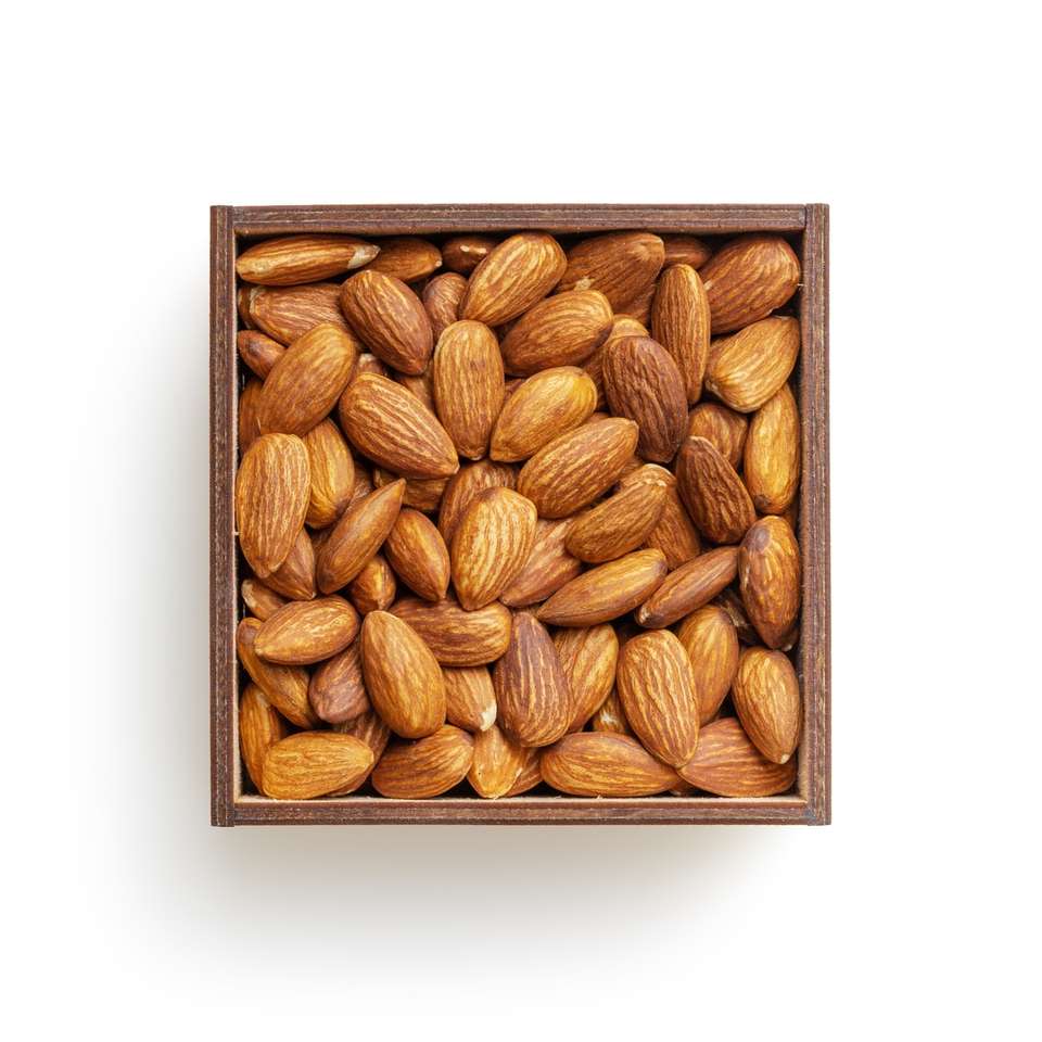 brown almond nuts on white surface online puzzle