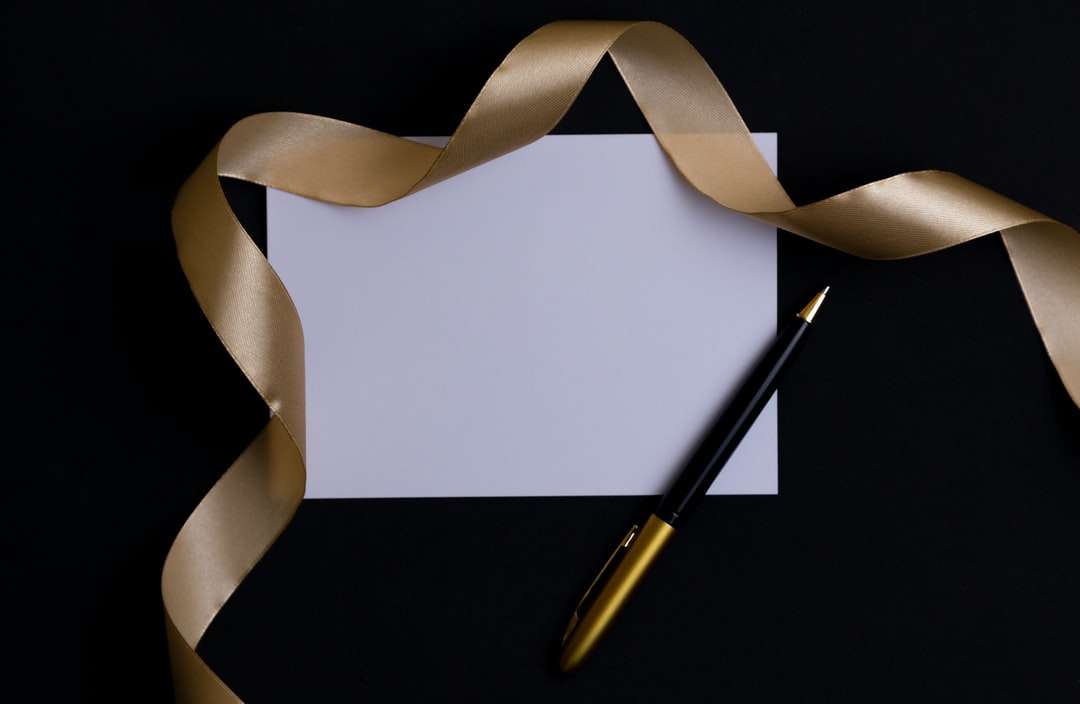 gold and silver pen on white paper online puzzle