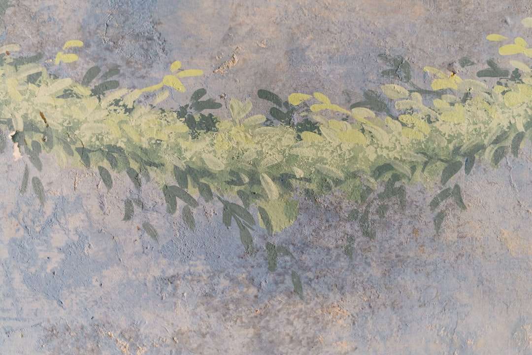 Gröna och gula löv på grått betonggolv pussel på nätet