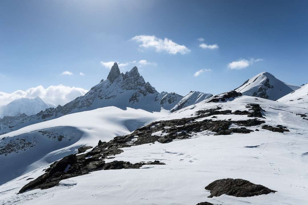 昼間は青空の下で雪に覆われた山 ジグソーパズルオンライン