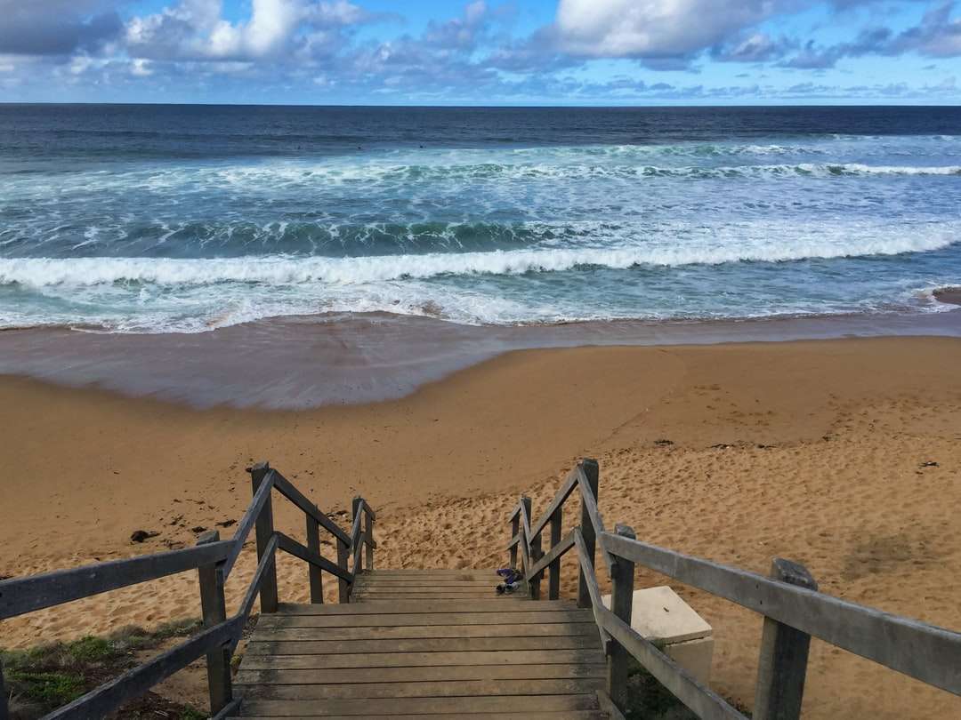 Doca de madeira marrom na praia durante o dia puzzle online