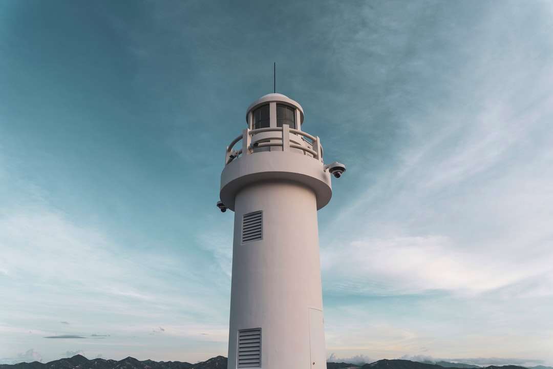white and black lighthouse under blue sky during daytime jigsaw puzzle online