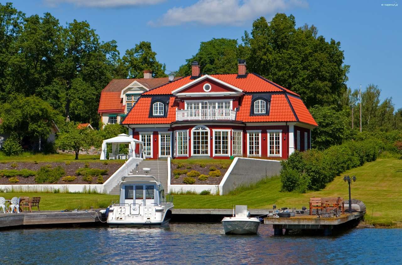 Hus vid sjön med en marina Pussel online