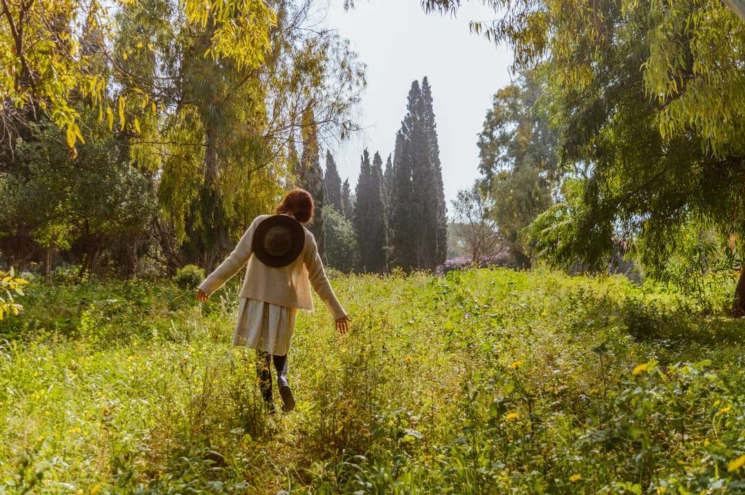 Vrouw in bruin jasje die zich op groen grasgebied bevindt legpuzzel online