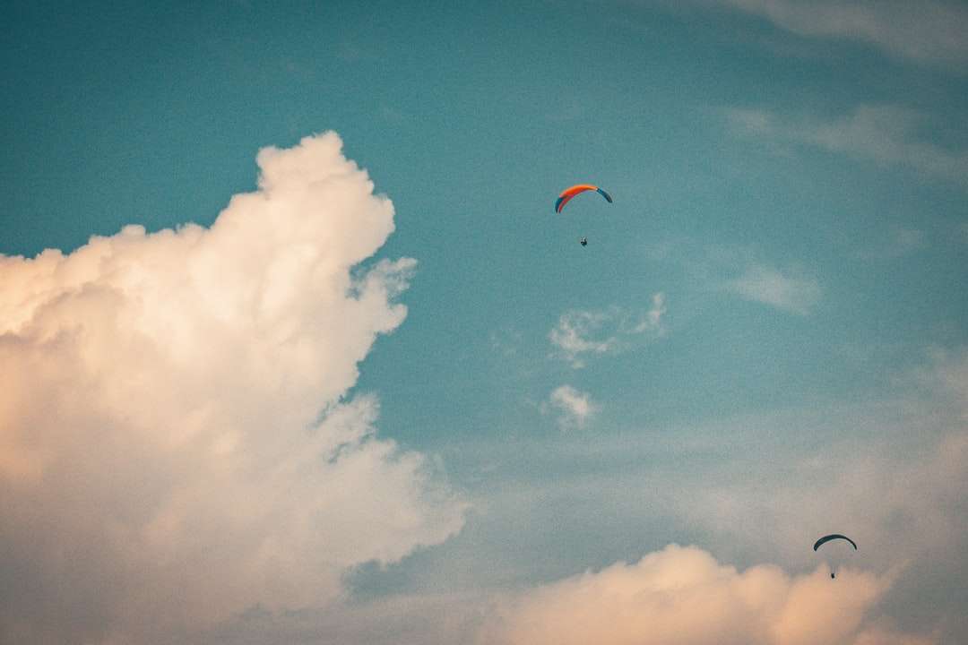 Πρόσωπο στο αλεξίπτωτο κάτω από τον μπλε ουρανό κατά τη διάρκεια της ημέρας online παζλ