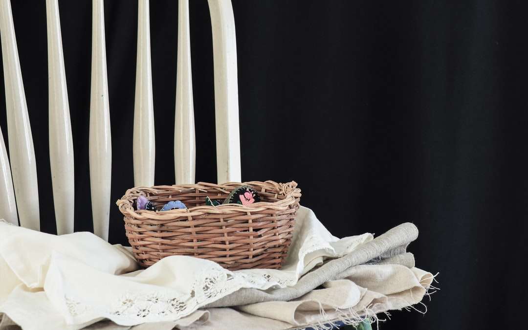 brown woven basket on white textile online puzzle