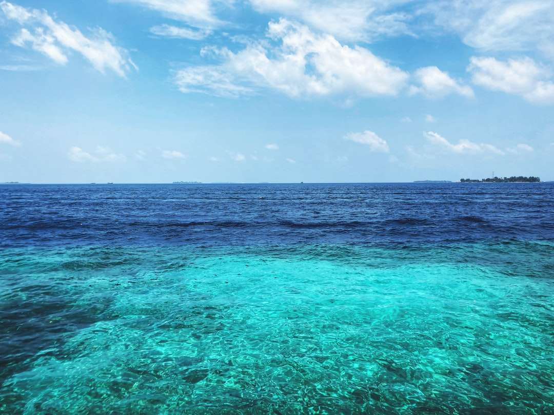 синьо море под синьо небе и бели облаци през деня онлайн пъзел