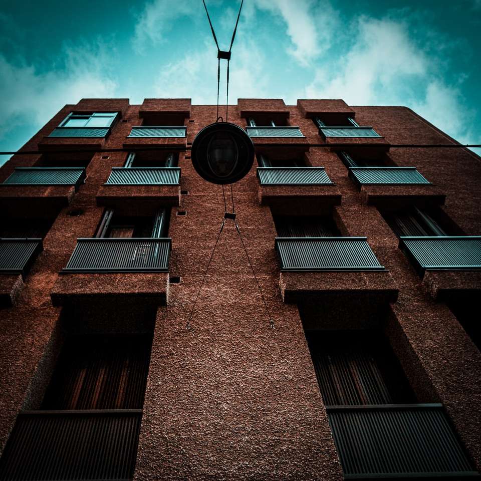 Edificio in mattoni marrone sotto il cielo blu puzzle online
