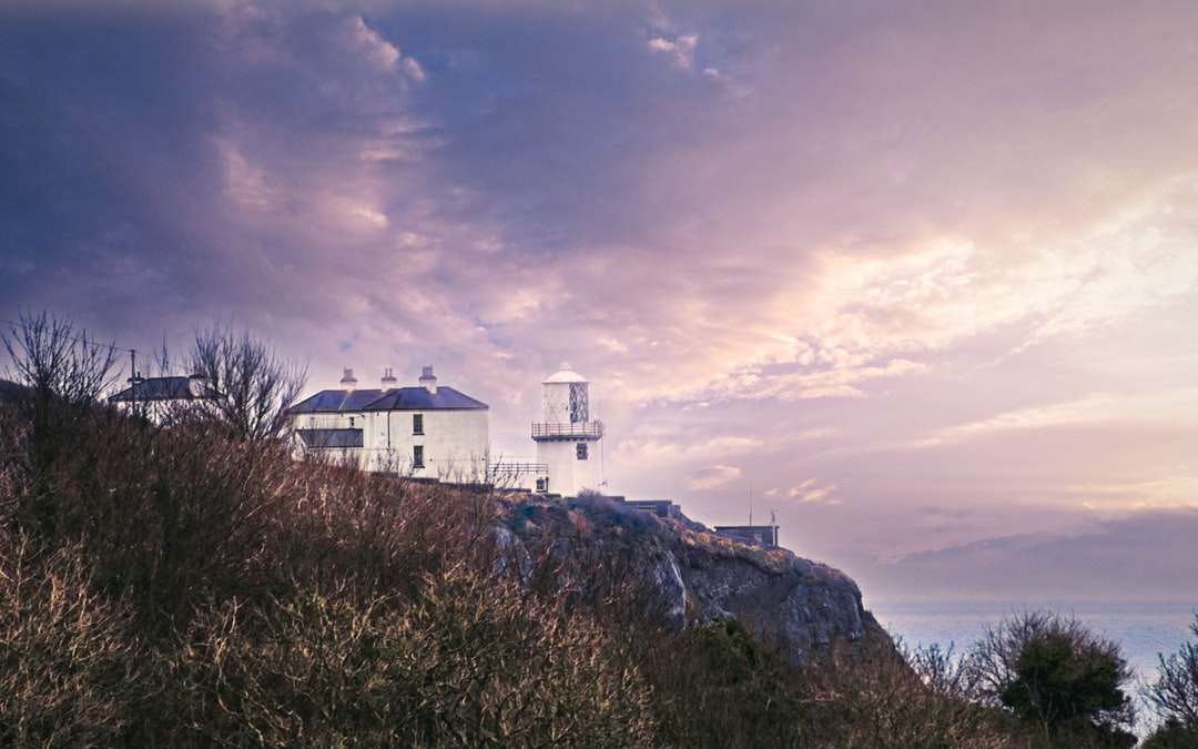 Bílá betonová budova na vrcholu kopce pod zatažené obloze skládačky online