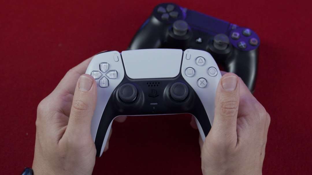 person holding black game controller online puzzle