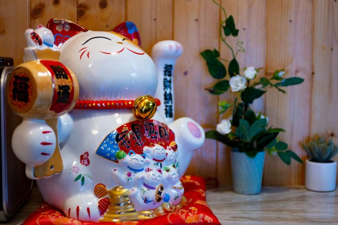 Estatueta de gato cerâmico vermelho e branco puzzle online