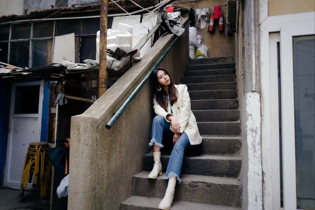 階段に座っている白いジャケットの女性 オンラインパズル