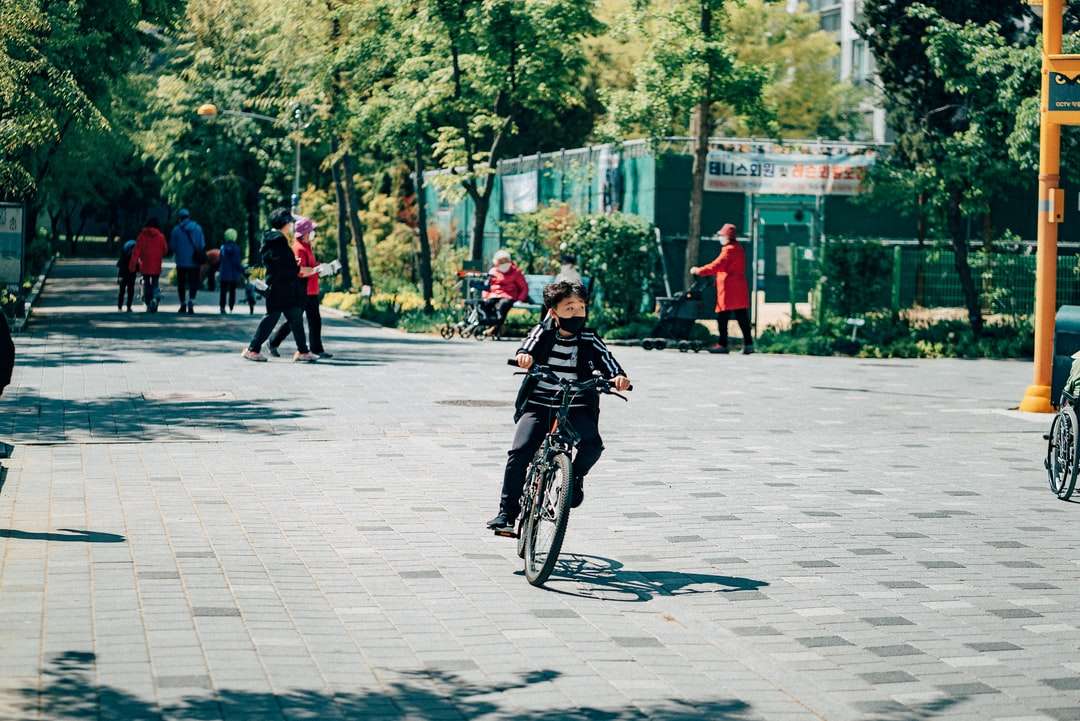 άντρας σε μαύρο σακάκι ιππασία ποδήλατο στο δρόμο κατά τη διάρκεια της ημέρας παζλ online