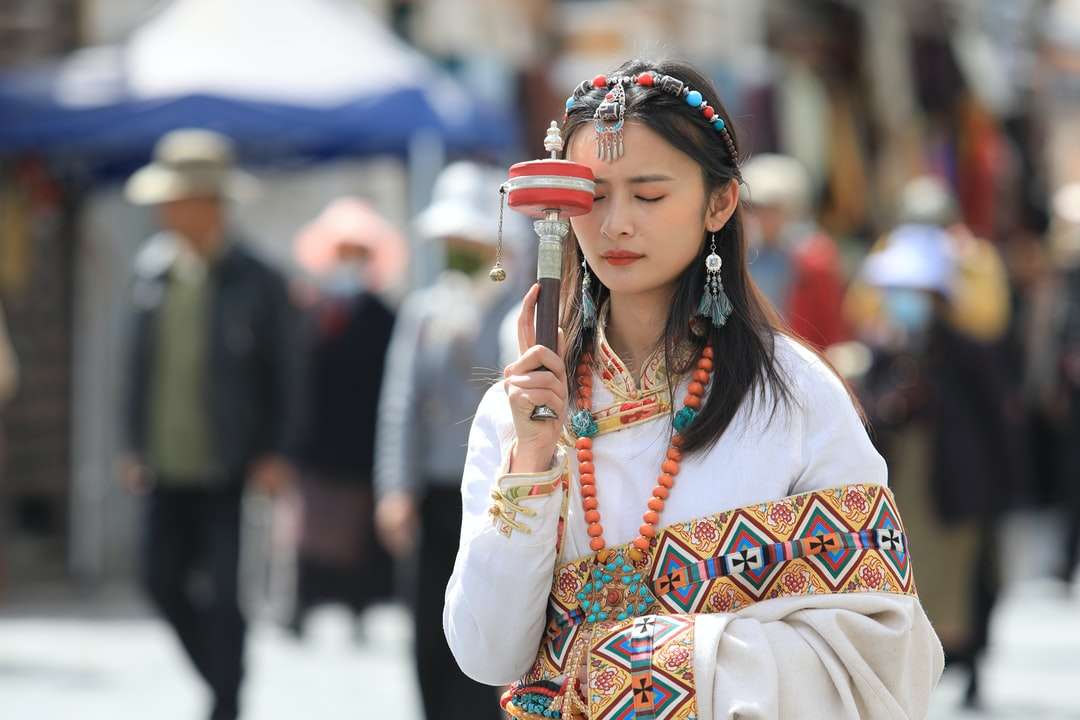Žena v bílé s dlouhým rukávem košile drží smartphone online puzzle