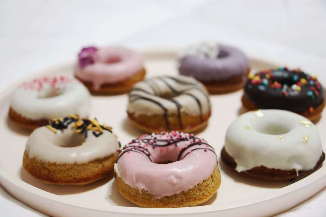 Chocolade doughnut met witte suikerglazuur op witte keramische plaat online puzzel