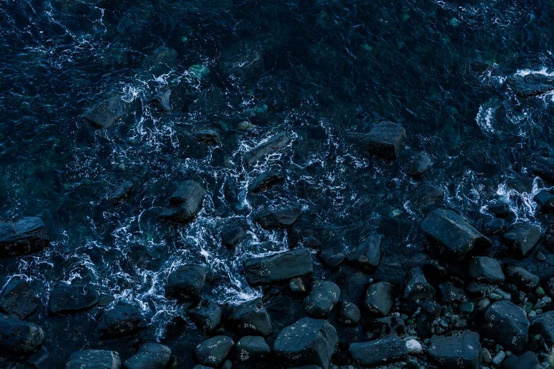 Γκρίζοι βράχοι στο σώμα του νερού κατά τη διάρκεια της ημέρας online παζλ