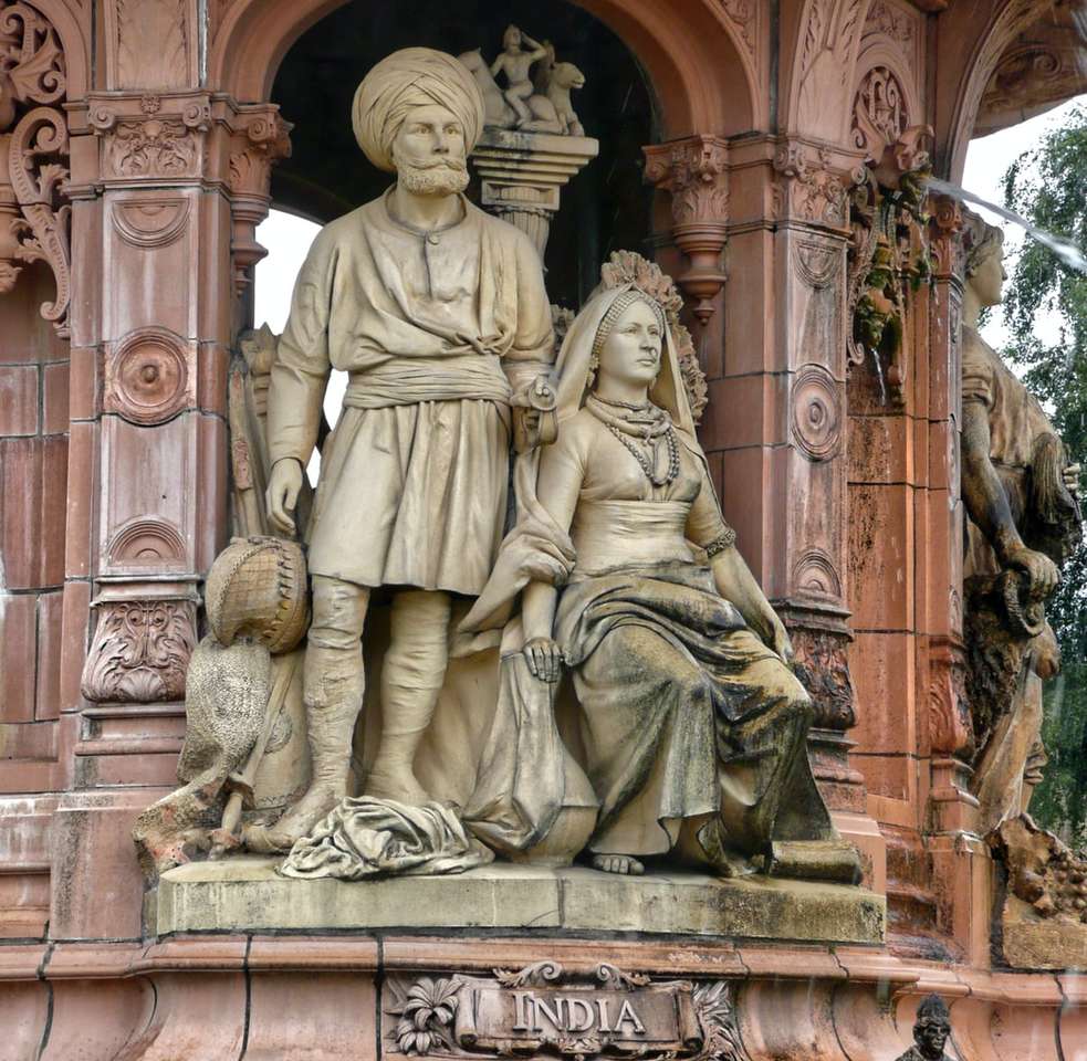 guld staty av man och kvinna pussel på nätet