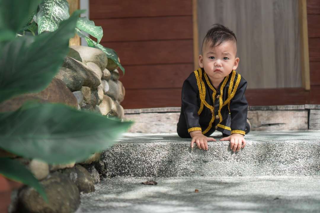 boy in black and yellow zip up jacket online puzzle