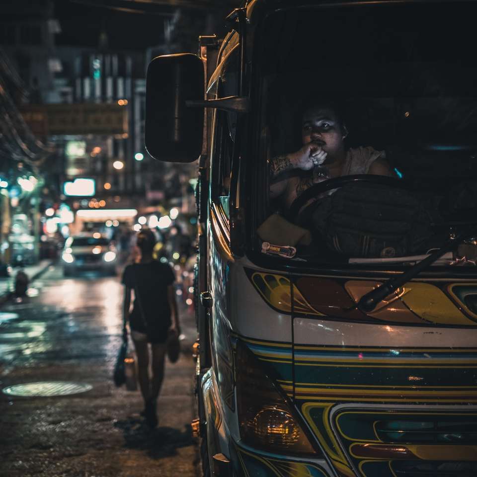 мъж в черно яке, стоящ до жълт автобус онлайн пъзел