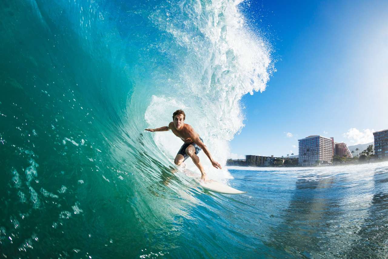 Surfer op blauwe oceaangolf legpuzzel online