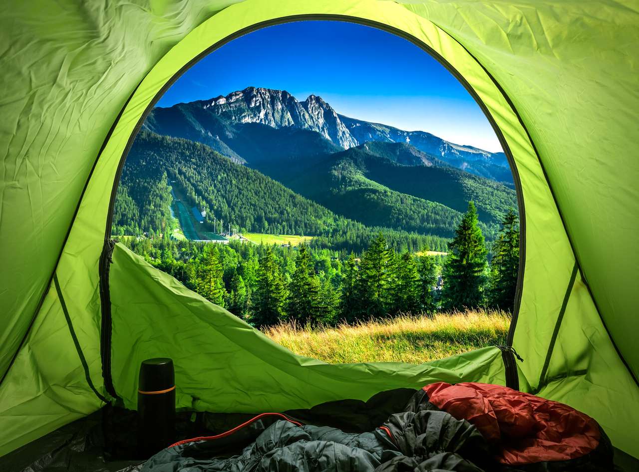 Blick vom Zelt zum Sonnenuntergang in den Bergen im Sommer Puzzlespiel online