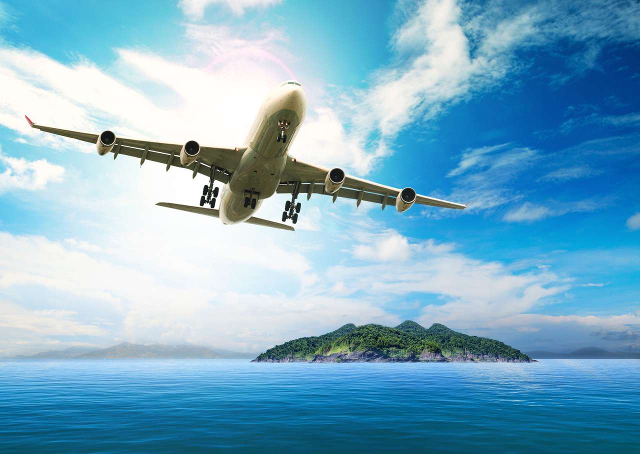 avión de pasajeros sobre hermosa isla rompecabezas en línea