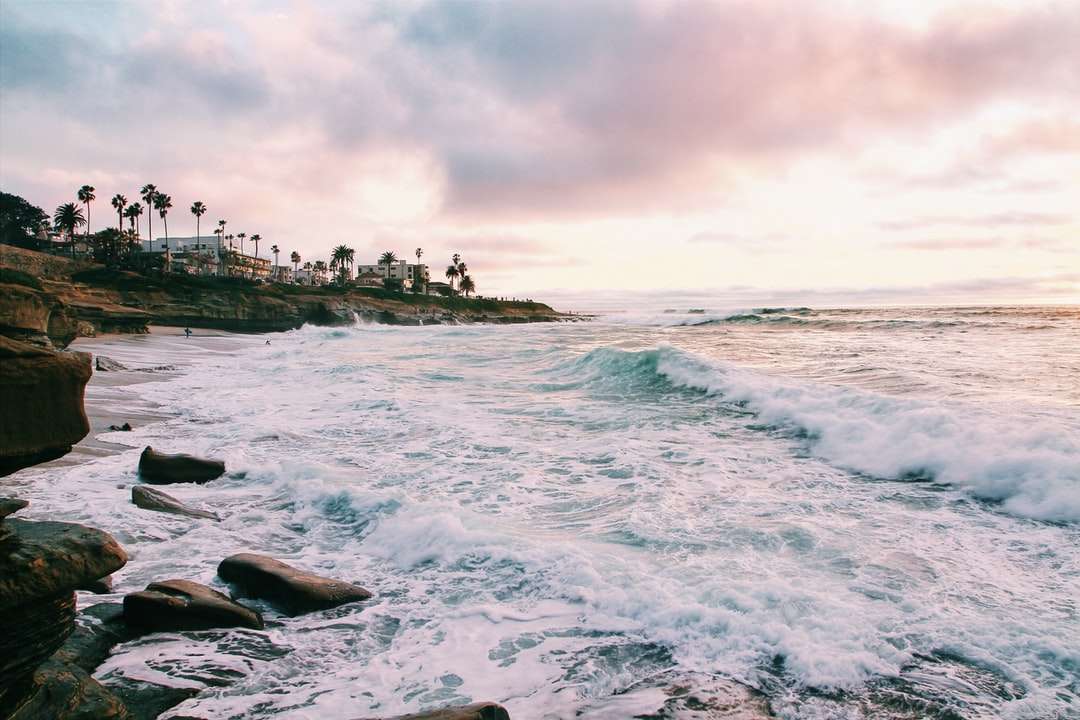 морските вълни се разбиват на брега по време на златния час онлайн пъзел