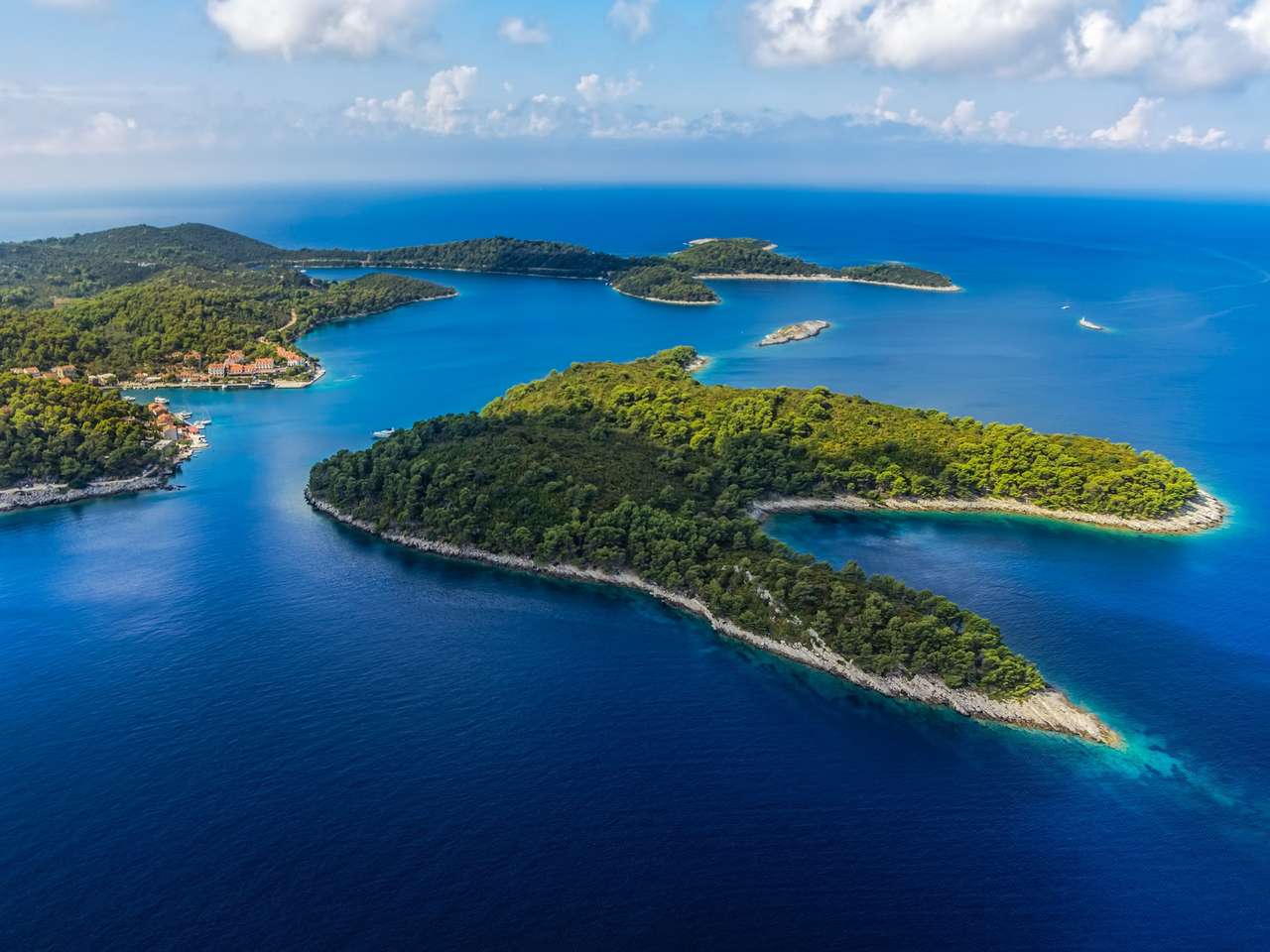 Aerial helicopter shoot of National park on island Mljet, village Pomena, Dubrovnik archipelago, Croatia. The oldest pine forest in Europe preserved. jigsaw puzzle online