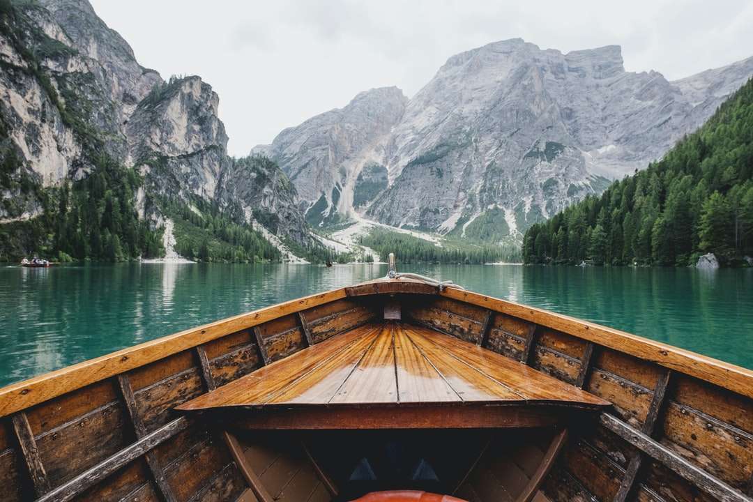 кафявата дървена лодка, която се движи към планината онлайн пъзел