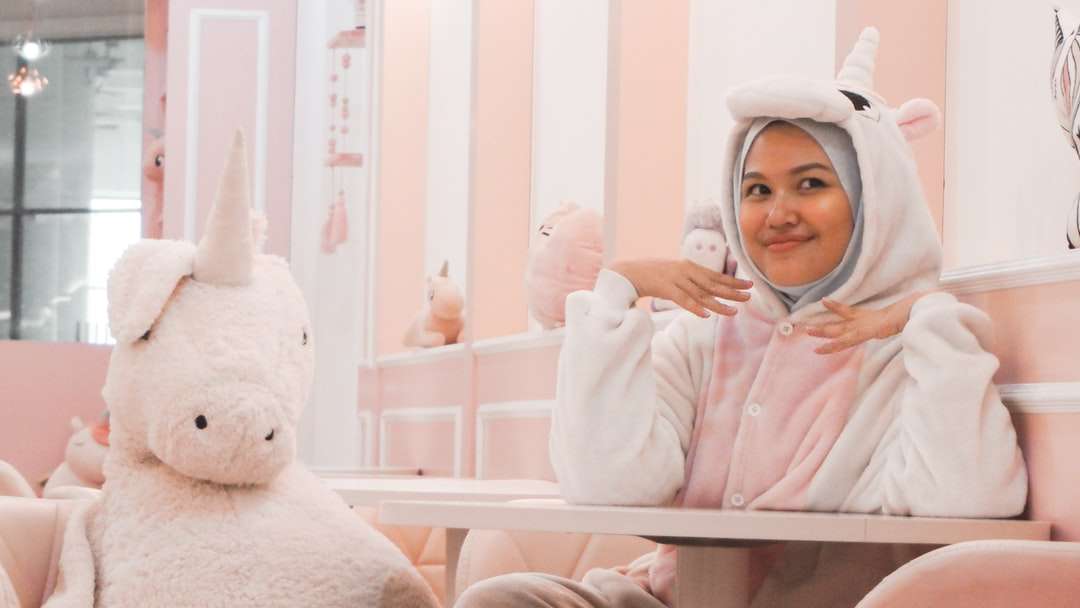 woman wearing white-and-pink unicorn costume sitting chair online puzzle