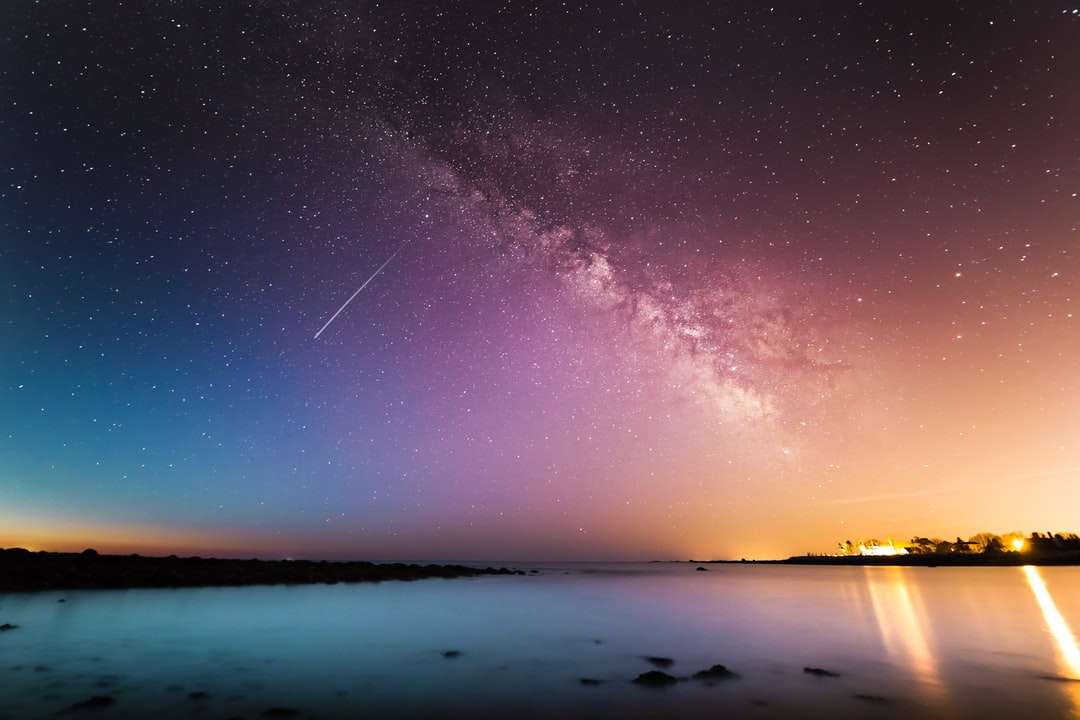 milky way above body of water online puzzle