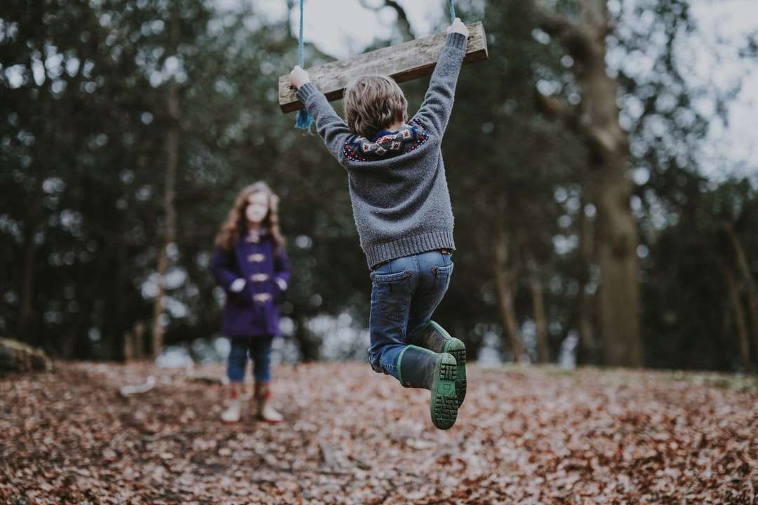 boy holding on swing bench online puzzle