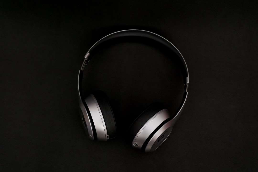 silver headphones on top of black surface online puzzle
