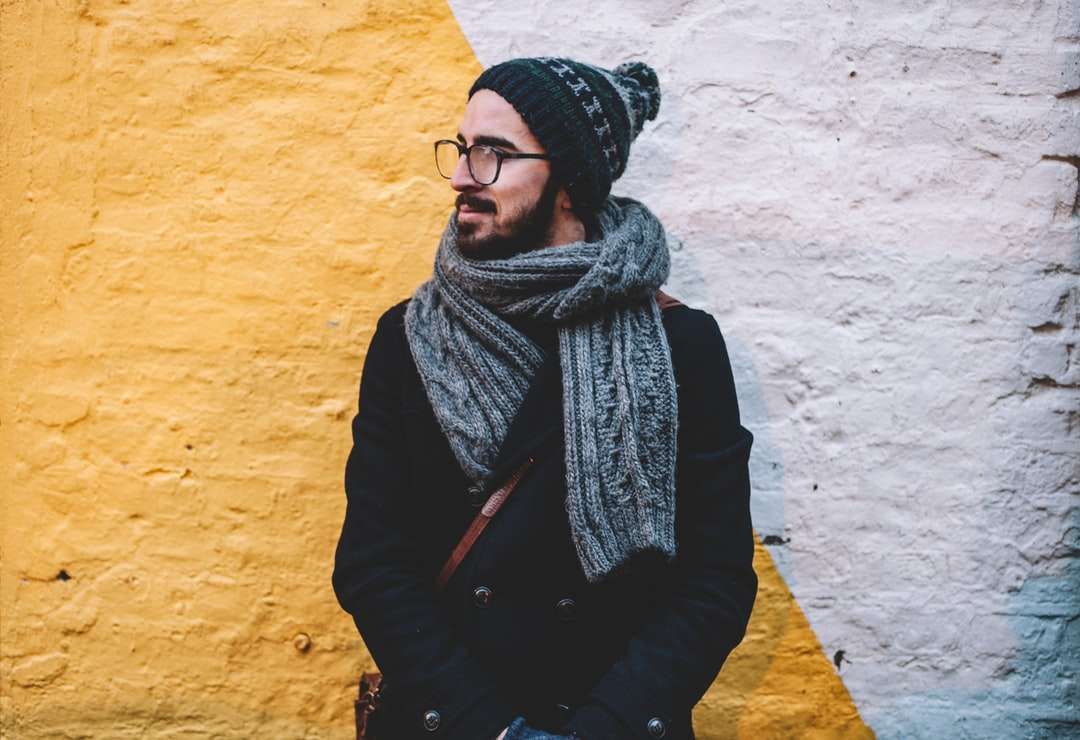 мужчина в черном пальто с серым шарфом стоит впереди онлайн-пазл