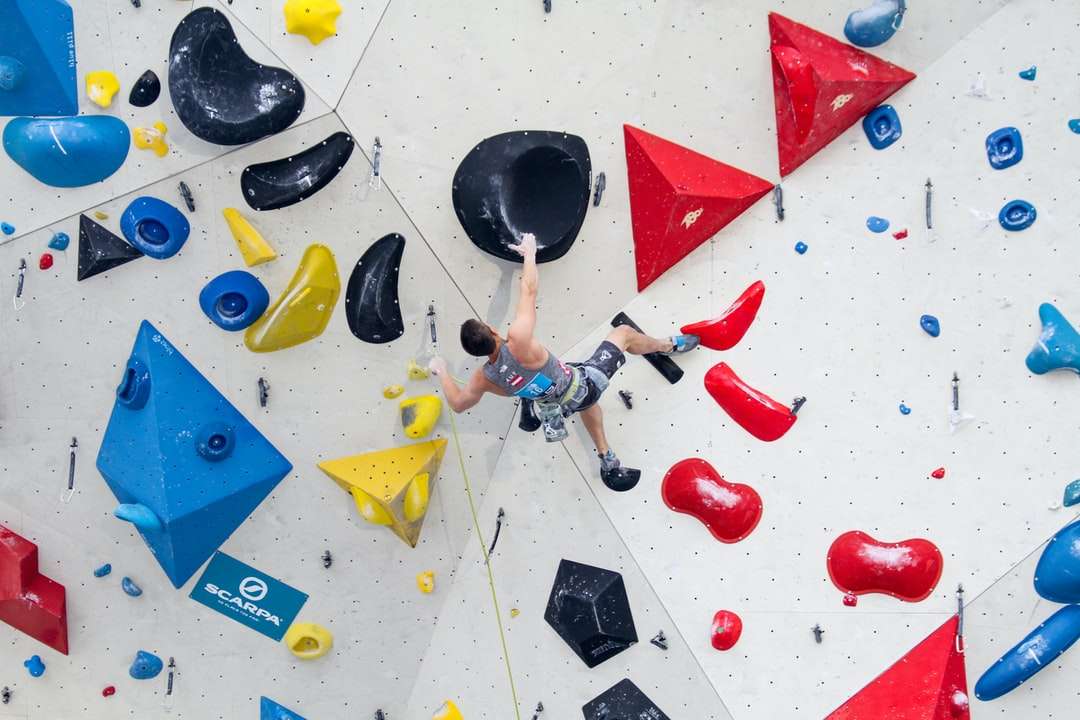 man wearing gray tank top climbing on wall jigsaw puzzle online
