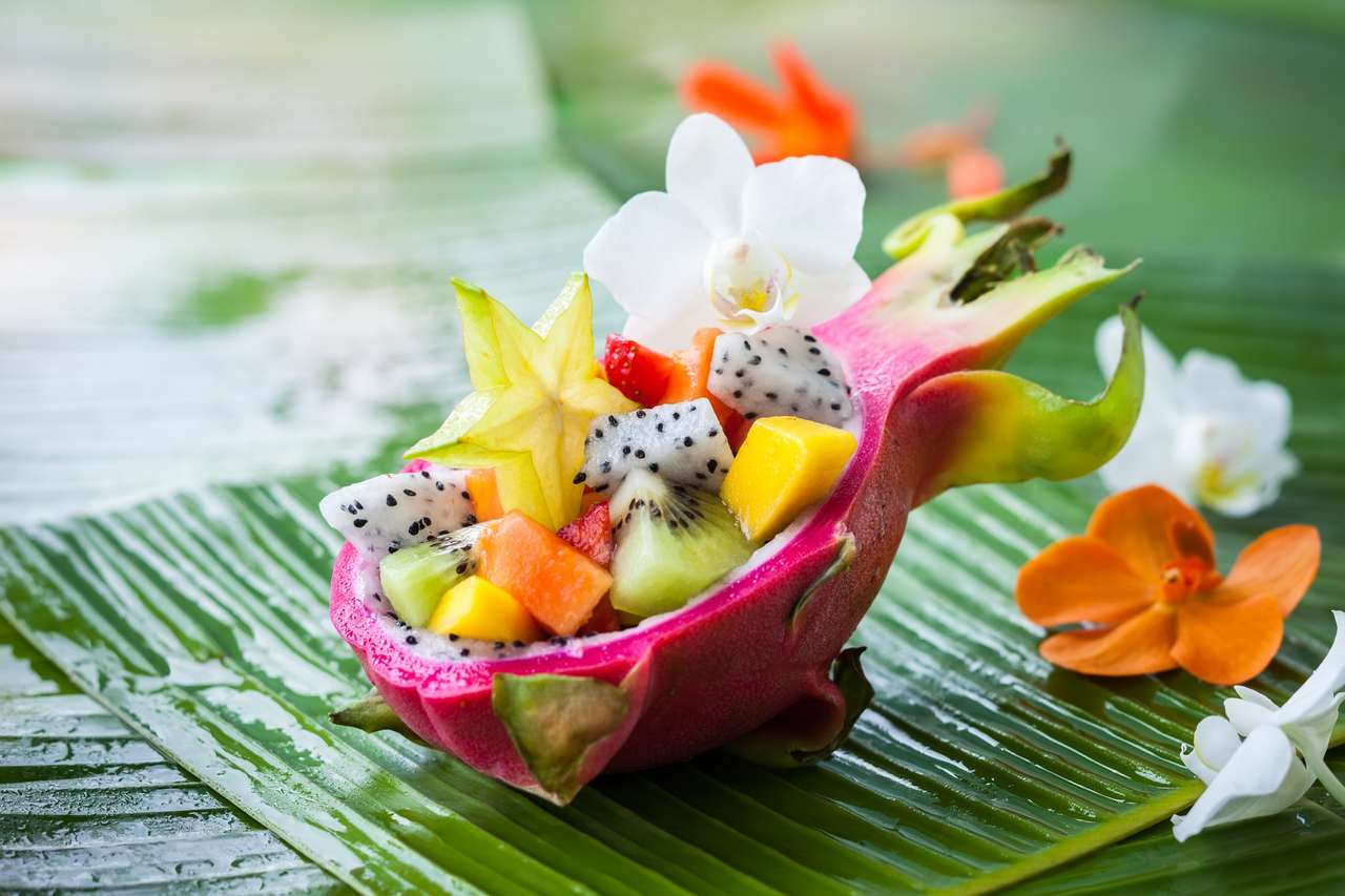 Salade de fruits exotiques servie dans un demi-dragon fruit puzzle en ligne