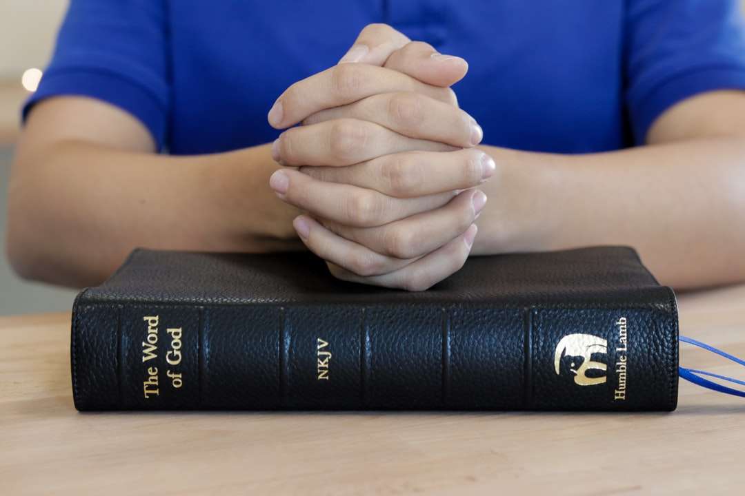 person infront of bible book jigsaw puzzle online