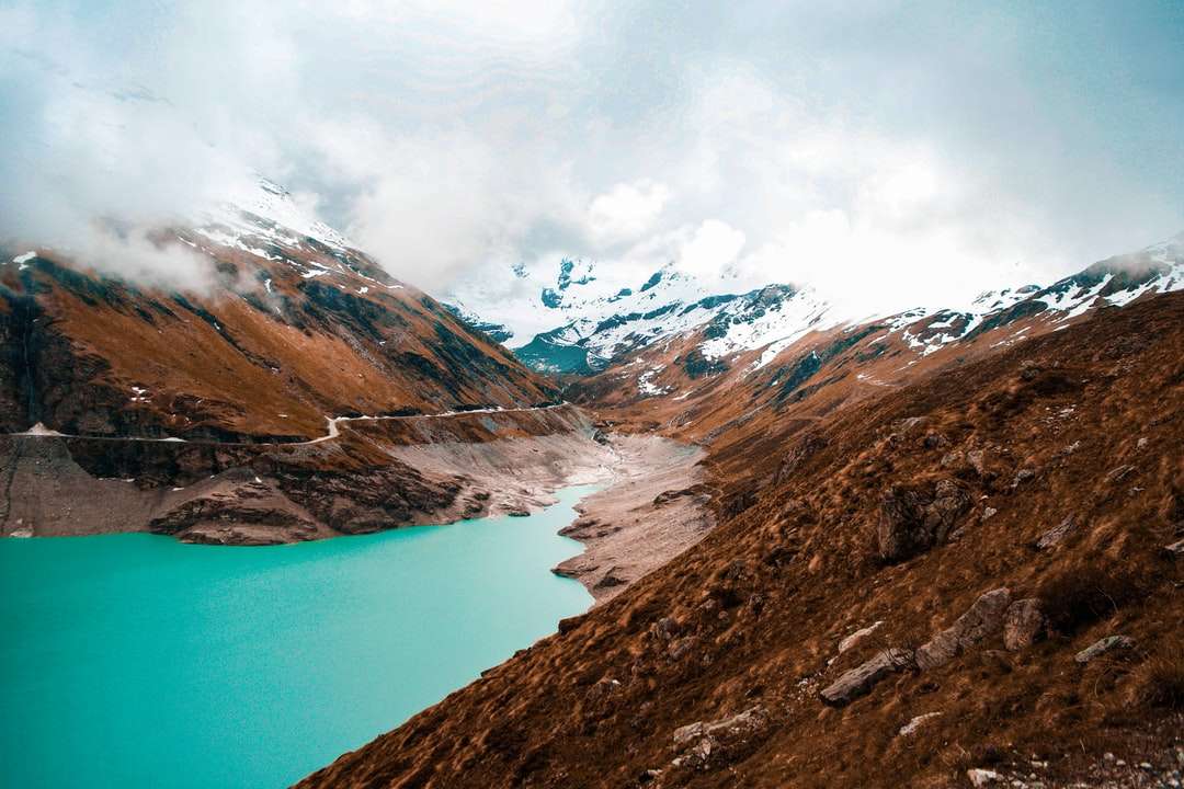 茶色の山々の風景写真の間の川 ジグソーパズルオンライン