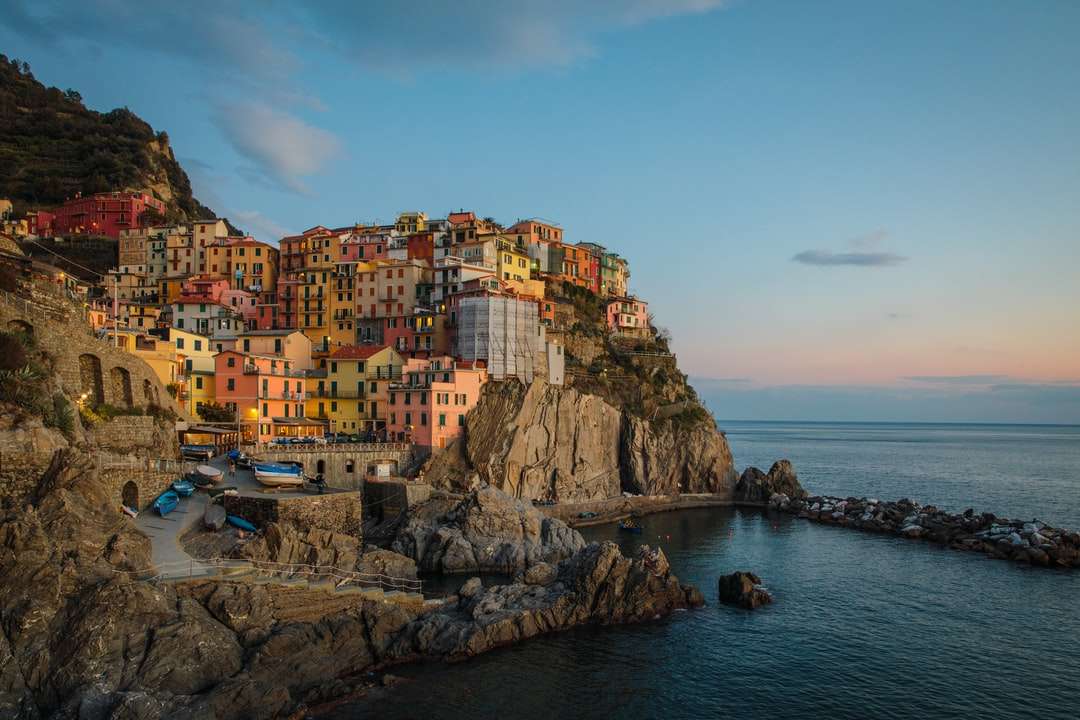 buildings near cliff under blue and white sky online puzzle