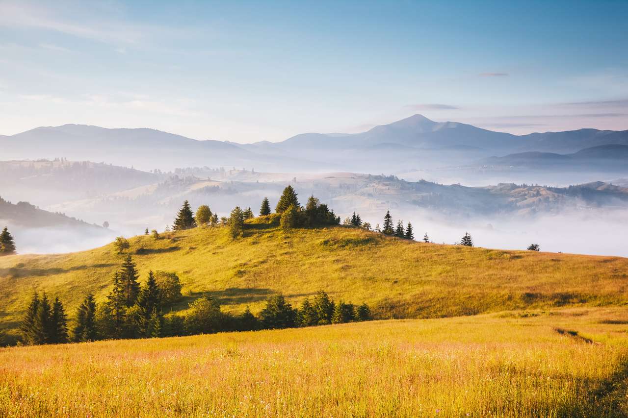 Misty alpine highlands in sunny day. jigsaw puzzle online