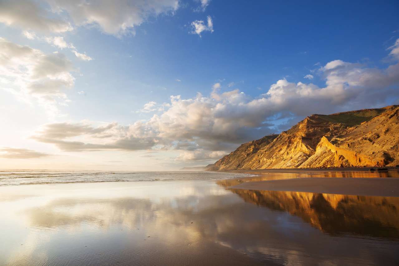 Belo pôr do sol na Ocean Beach, Nova Zelândia puzzle online