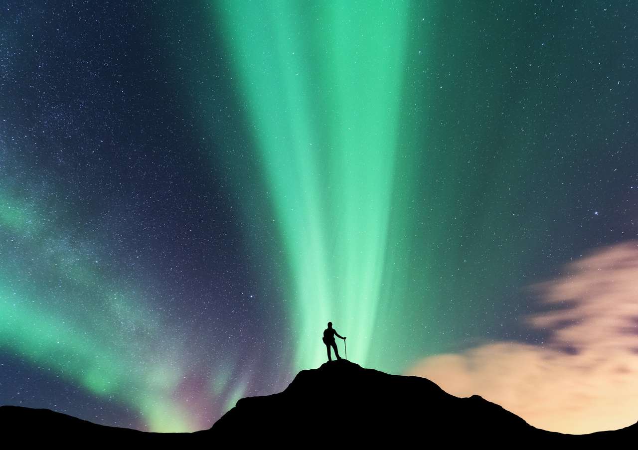 Aurora and woman on the top of mountain. online puzzle