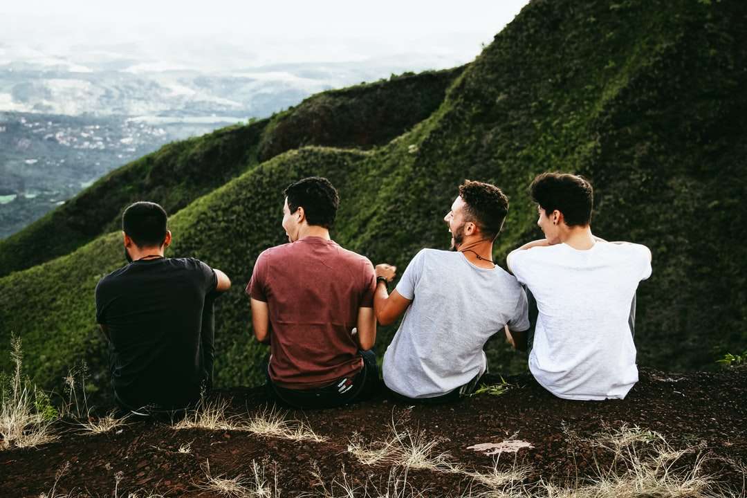 ряд из четырех мужчин, сидящих на горной тропе пазл онлайн