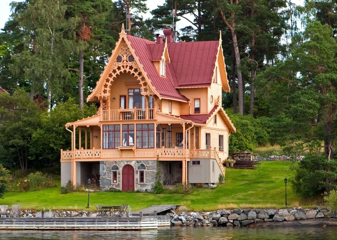 O vilă din lemn lângă râu puzzle online