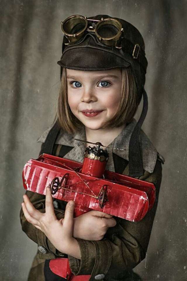 porträtt av en flicka med flygplan pussel på nätet